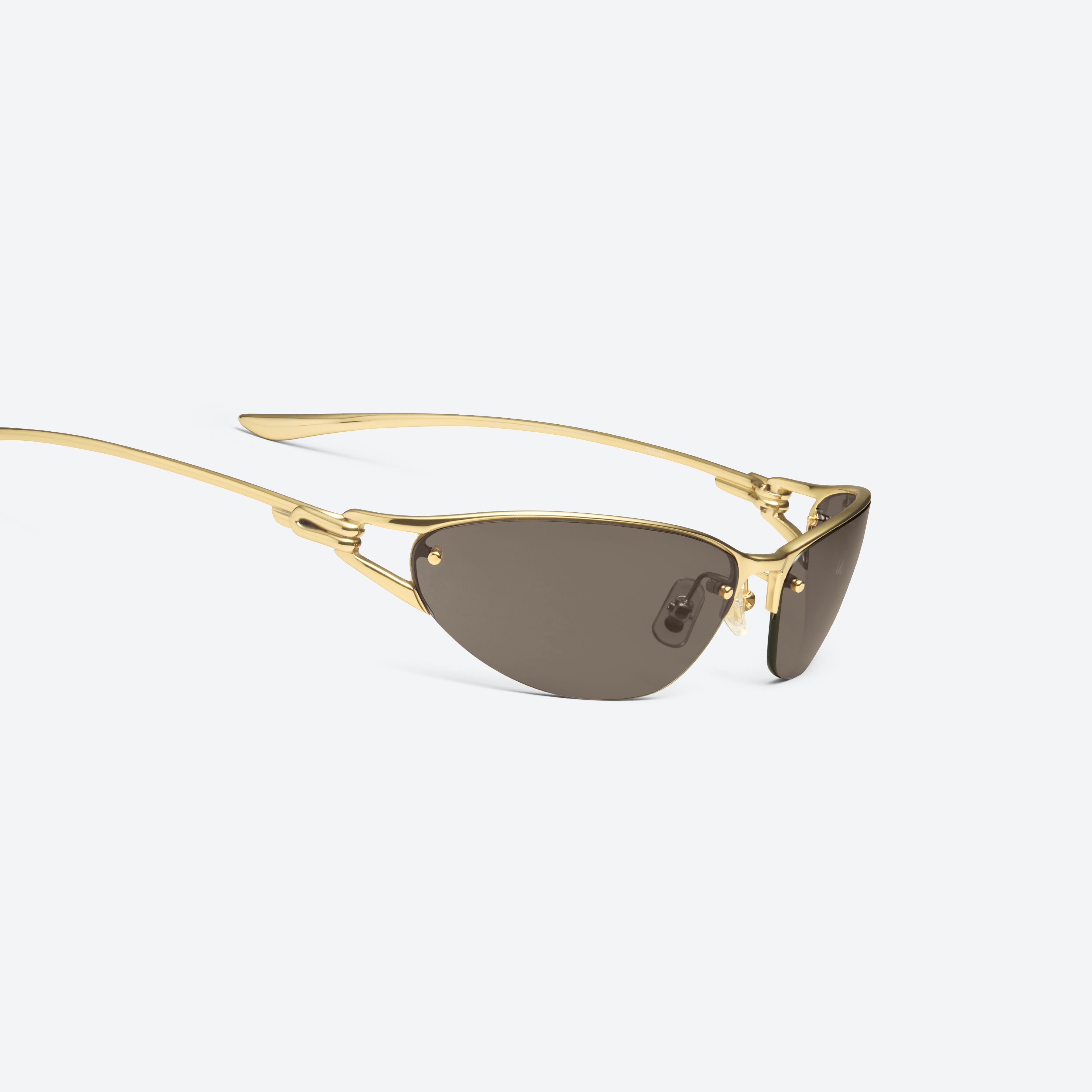 45-degree detailed view of Gentle Monster Futura 03 Gold Metal framed Wraparound sunglasses.