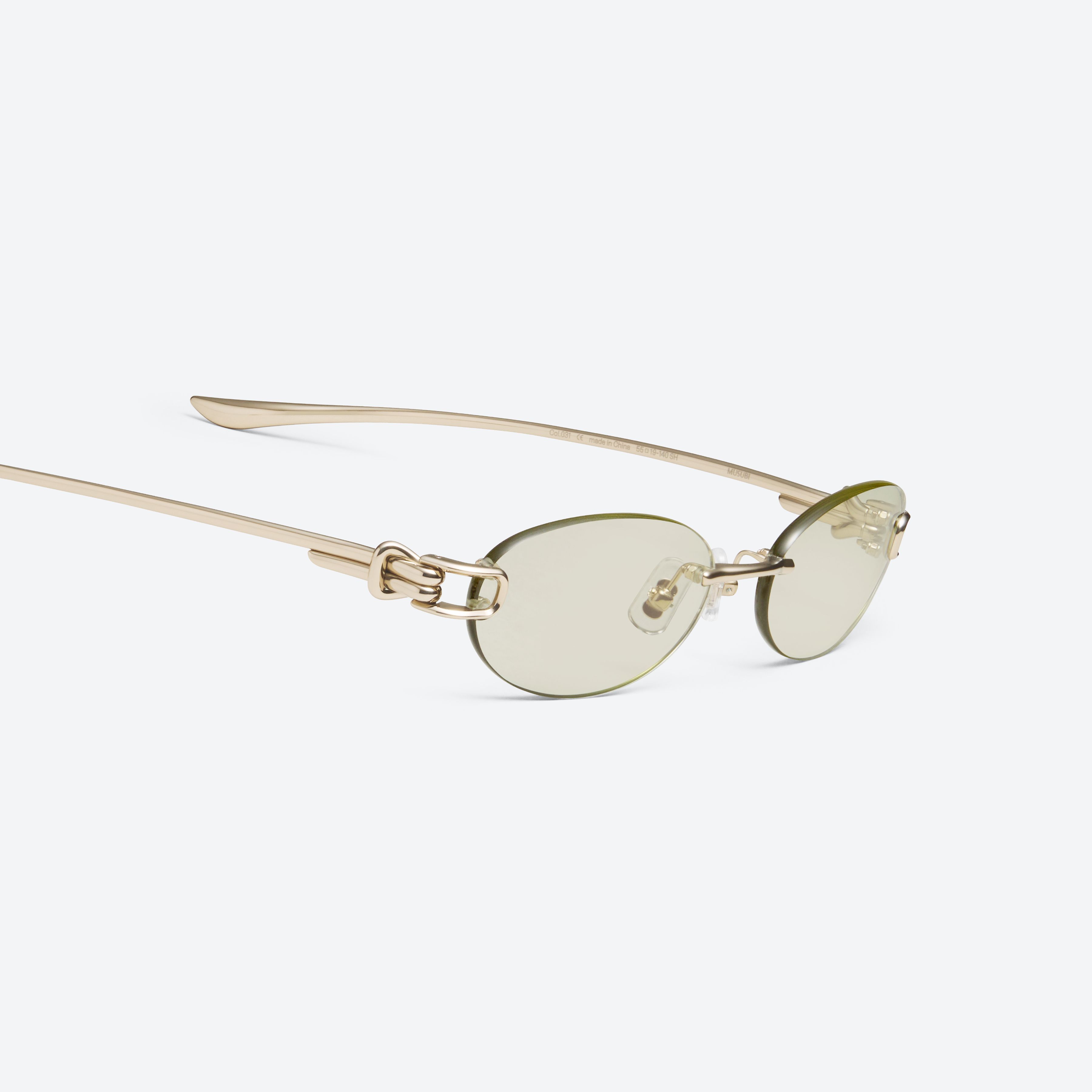 45-degree detailed view of Gentle Monster Musubi 031 Gold Metal framed Oval sunglasses.