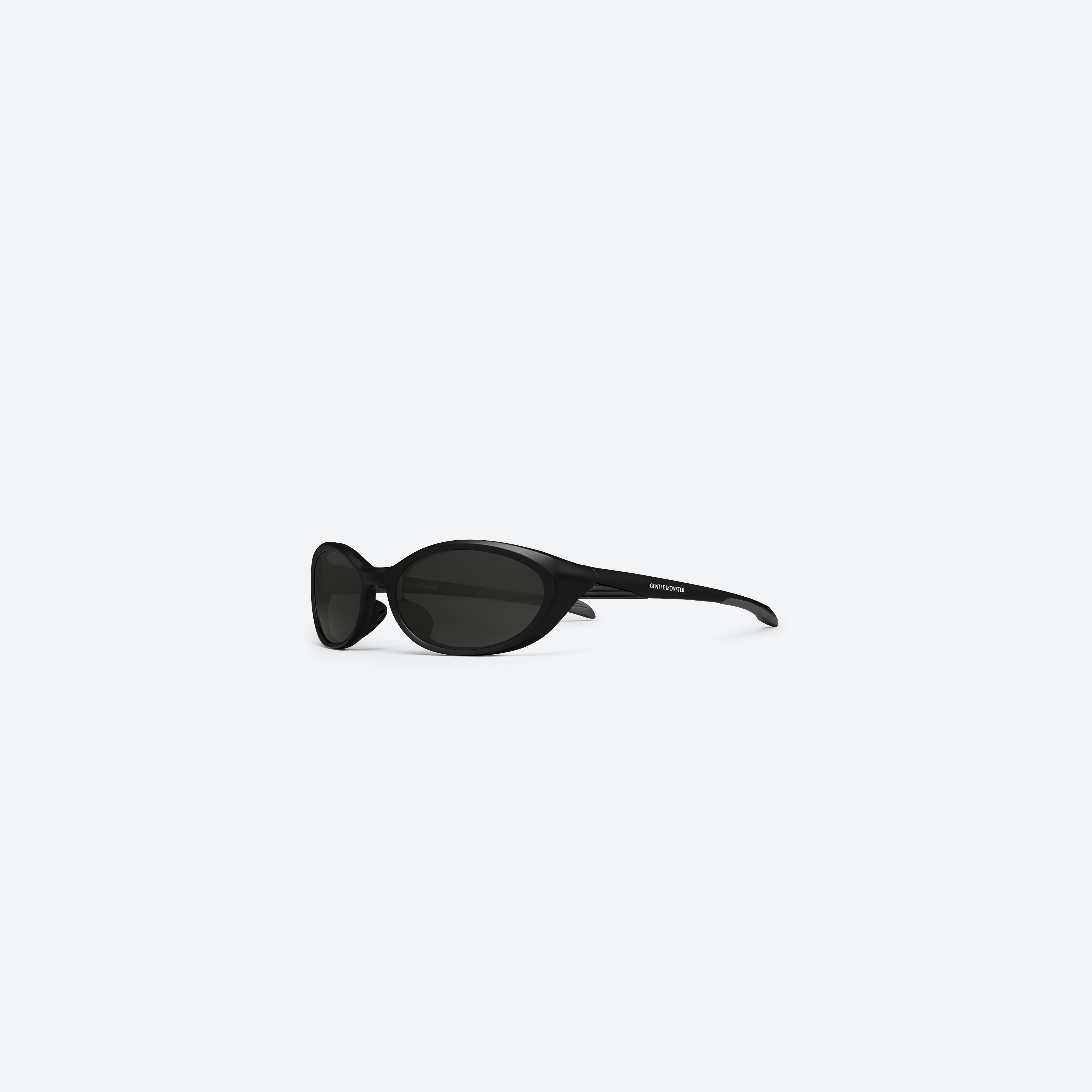 45-degree view of Gentle Monster Rim M01 Black Nylon framed Wraparound sunglasses.