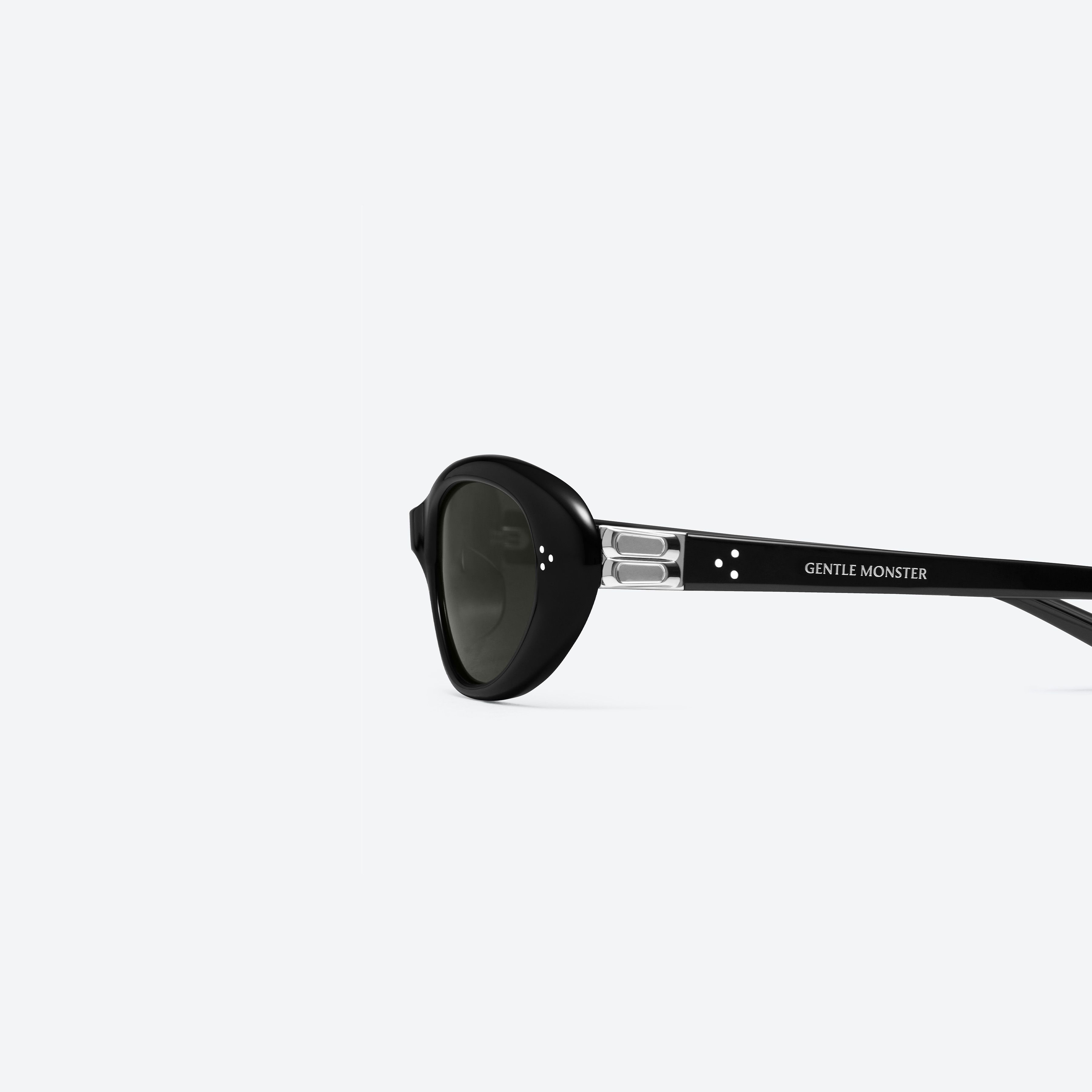 A detailed left view of Gentle Monster Cinnamon 01 Black Acetate framed Oval sunglasses.
