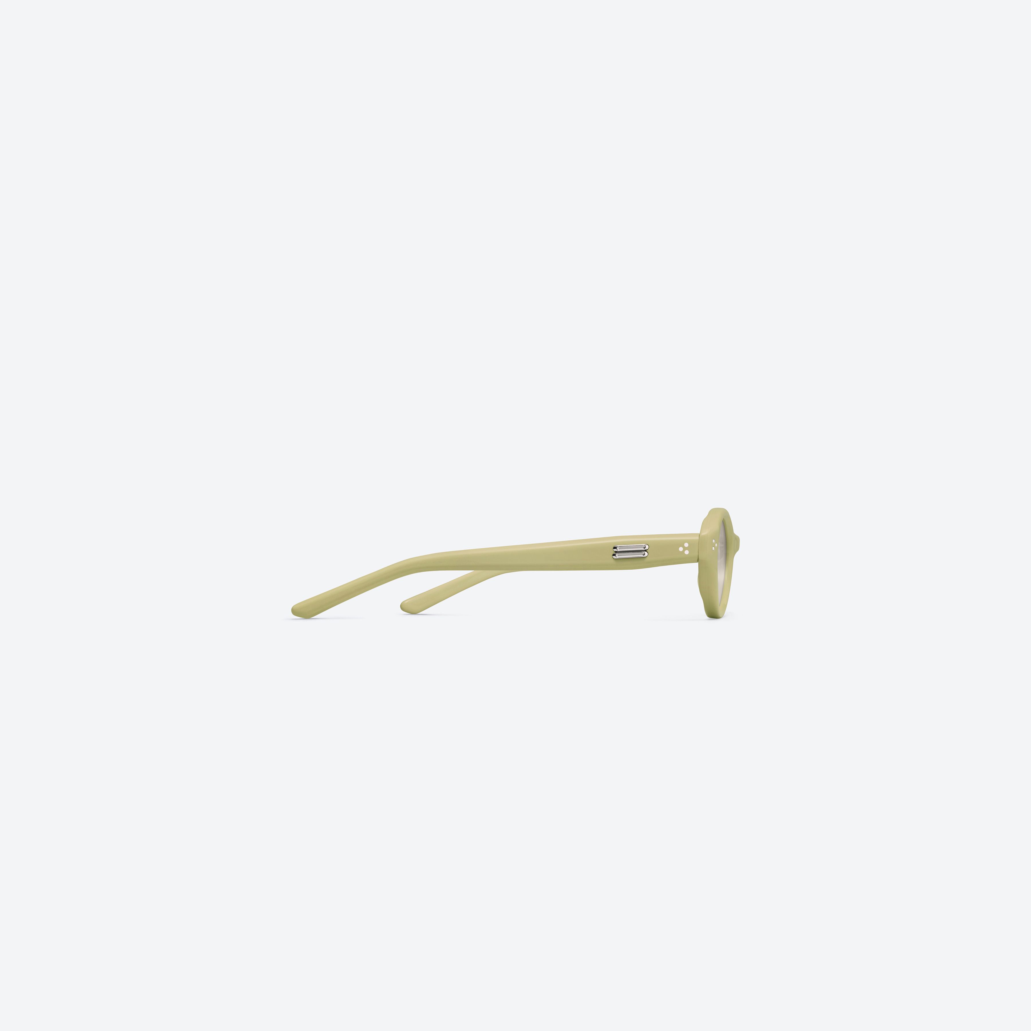 A detailed right view of Gentle Monster Cuscus Y11 Yellow Acetate framed Oval sunglasses.