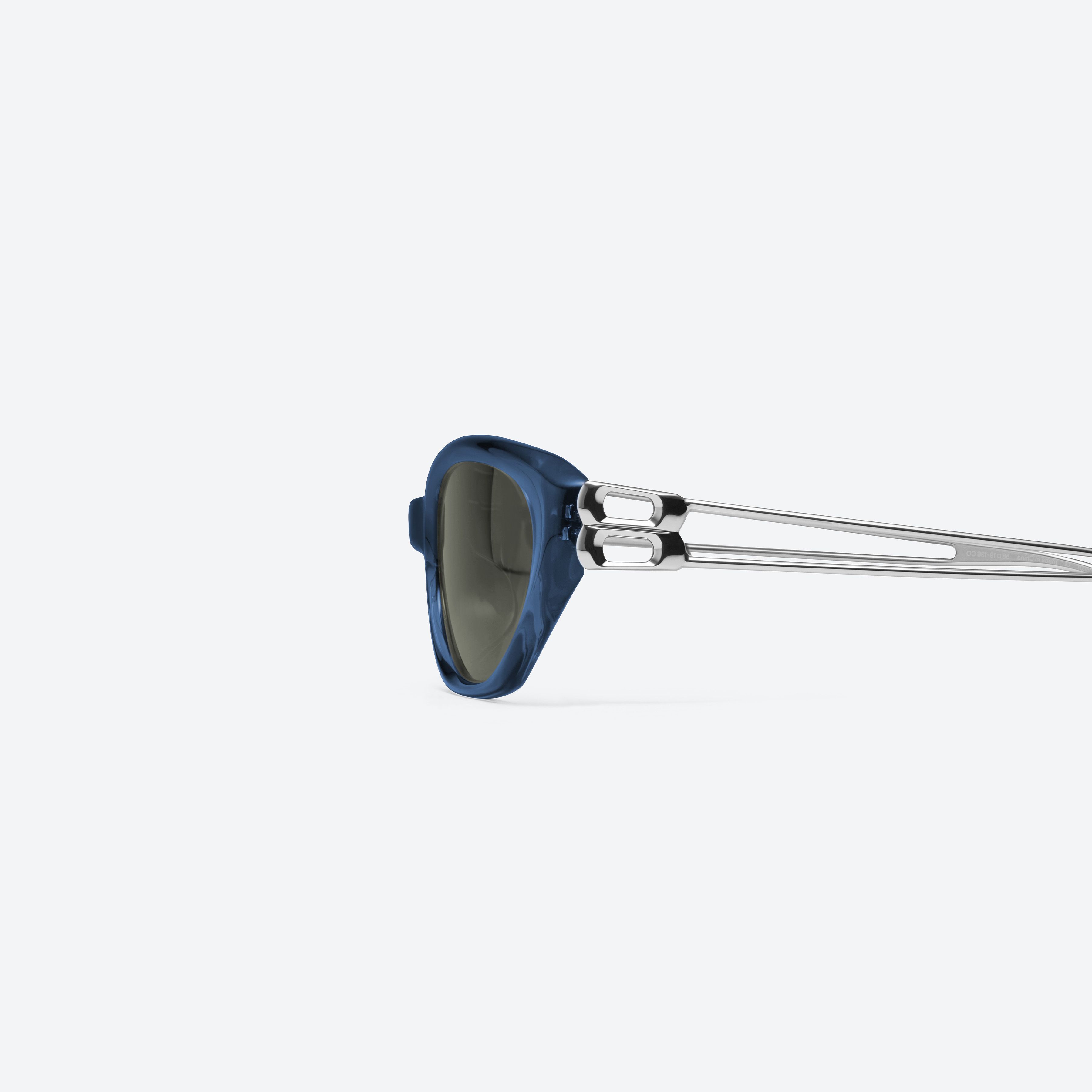 A detailed left view of Gentle Monster Mimosa NC2 Blue Mixed framed Cat-eye sunglasses.