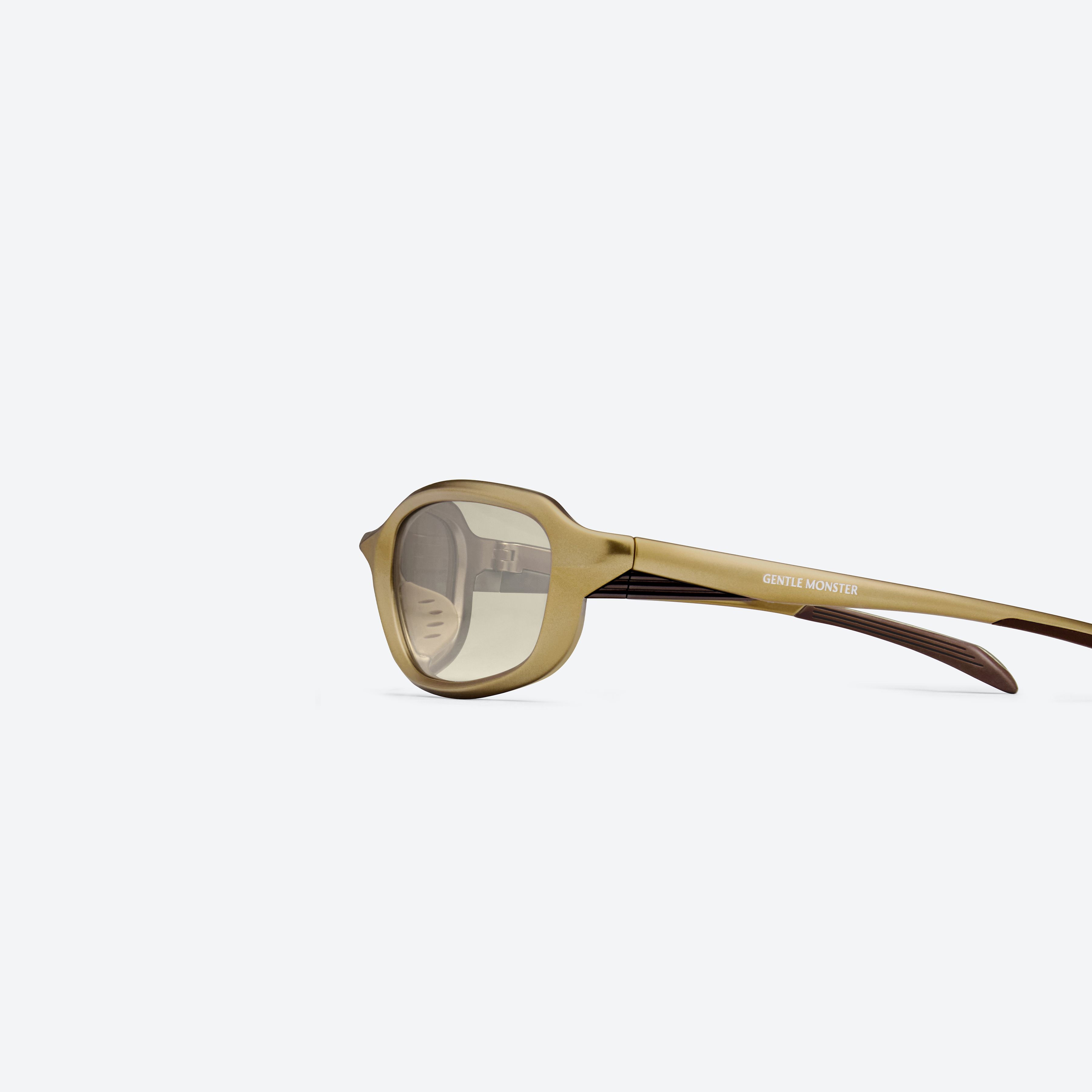 A detailed left view of Gentle Monster Volt MGD2 Gold Nylon framed Wraparound sunglasses.