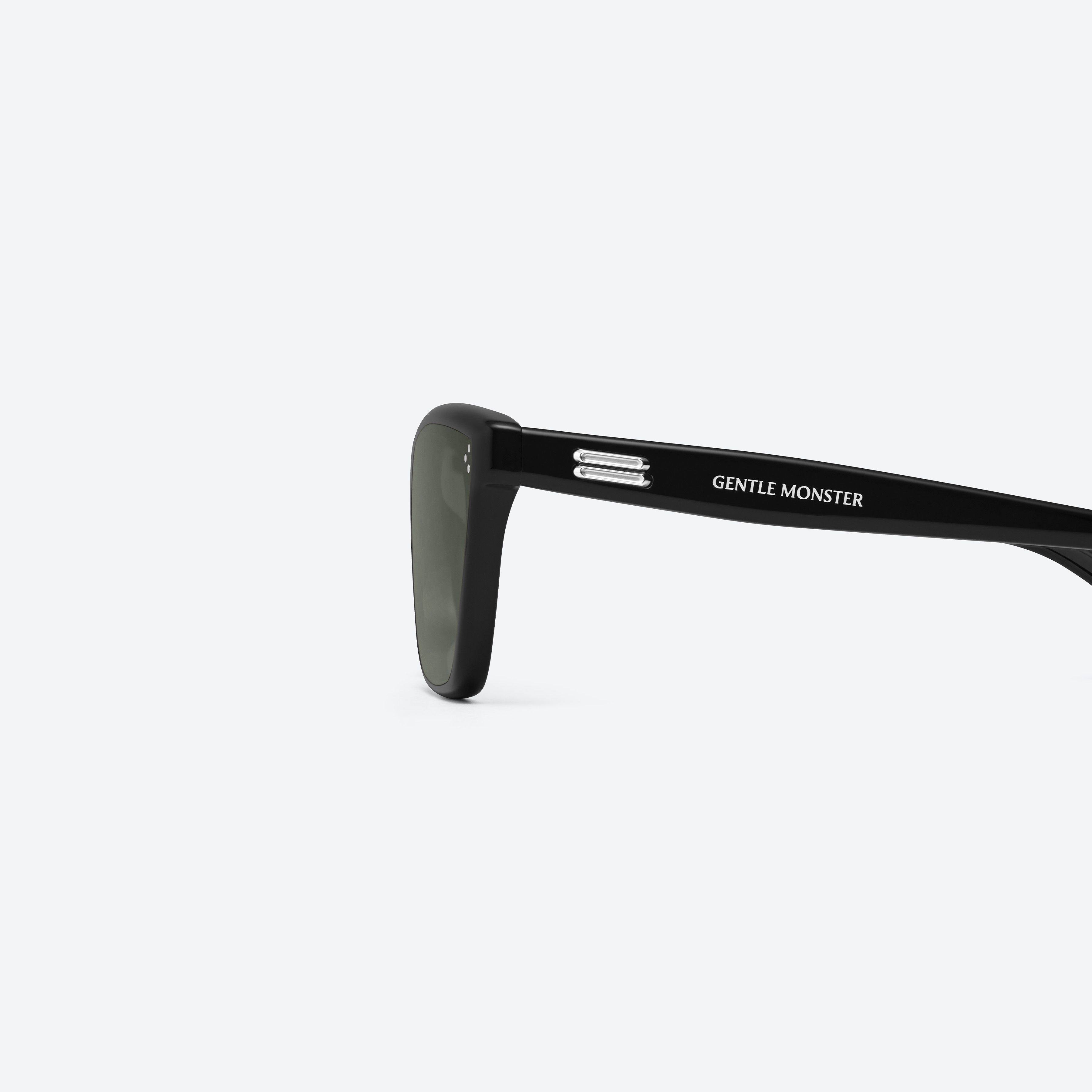 A detailed left view of Gentle Monster Dodo 01 Black Acetate framed Cat-eye sunglasses.